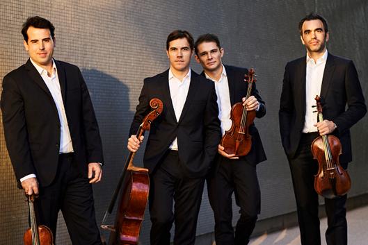 Four men with dark hair holding their chamber instruments